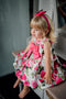 Pink dress with floral pattern and large bow