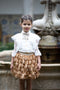 White blouse with tulle ruffles and velvet bow