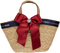 Straw basket with navy ribbon and red bow