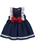 Navy blue dress with white ruffles and red bow