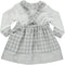 White blouse set with gray plaid skirt with straps and bows on the front