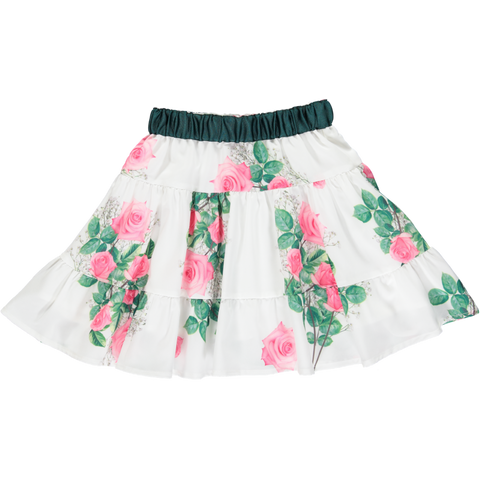 White flowing skirt with flower pattern and green belt