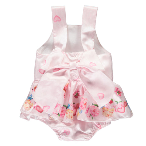 Pink strappy bodysuit with colorful pattern, ruffles and bow