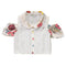 White blouse with colored buttons and beige floral pattern