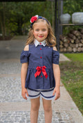 High and low navy blue polka dots and bow blouse